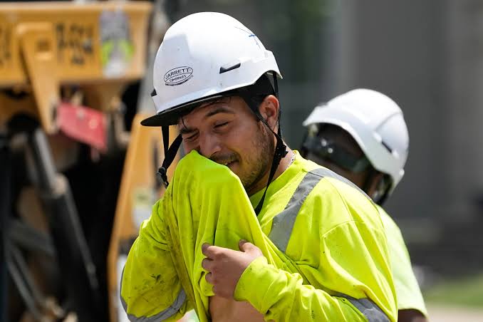 Man wiping sweat with his shirt
