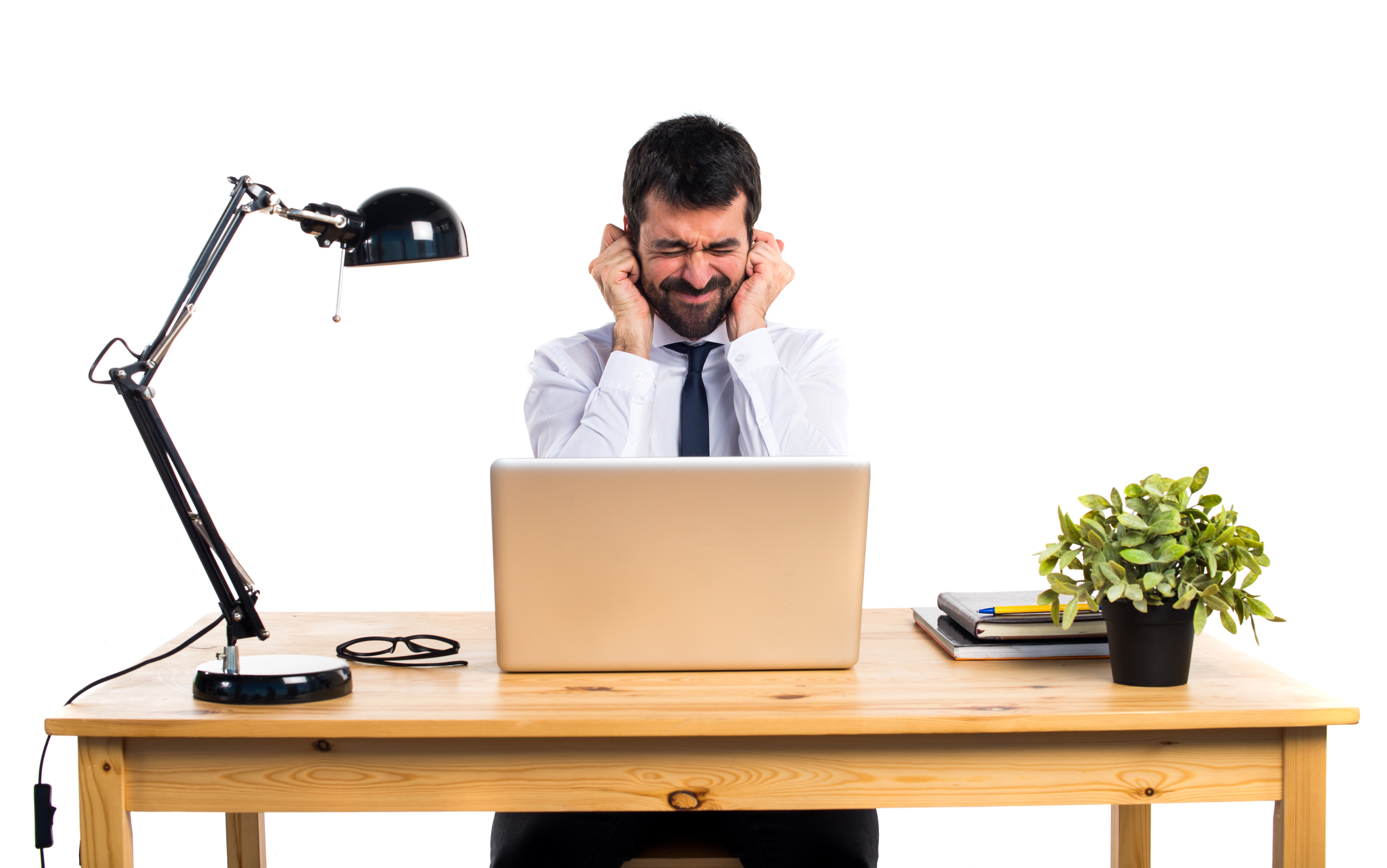 Man covering ears in a loud environment