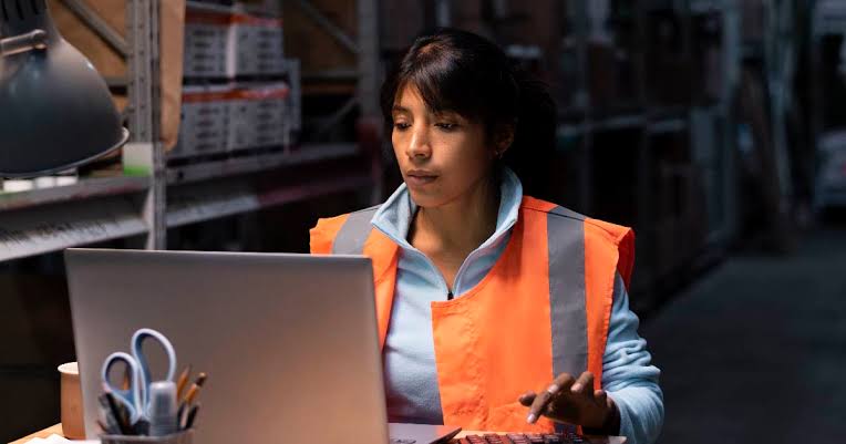 Lady in front of a laptop in low light