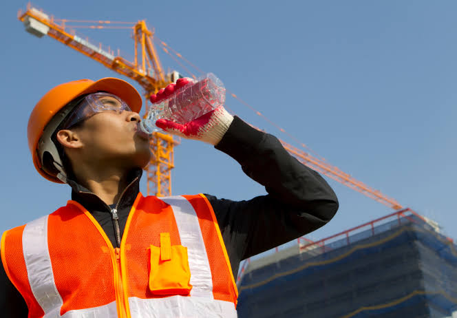 Man in the heat drinking water