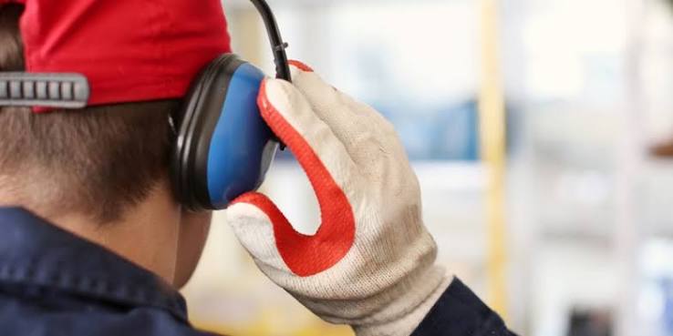 Man with hands over ear protection