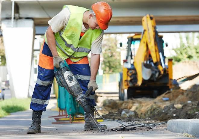 Man working with noisy grinder