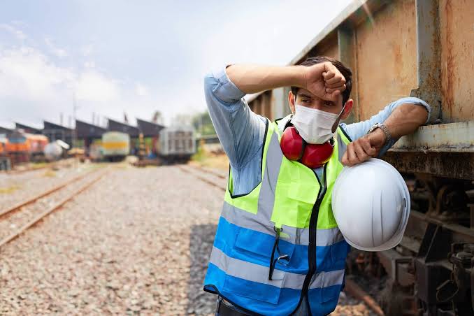 Man suffering under the heat in PPE
