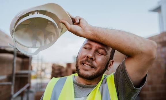 Construction wiping sweat from his brow